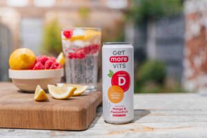 fruit on chopping board next to can