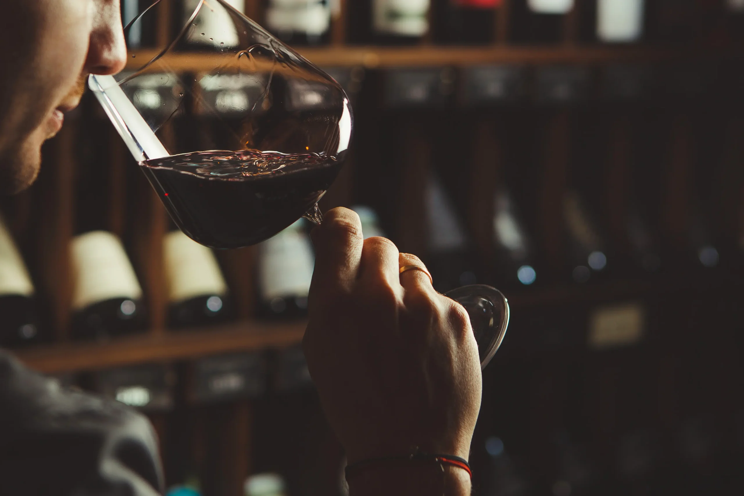 a person smelling wine in a glass